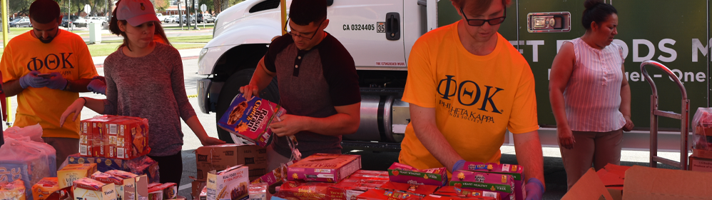 Student volunteers hand out food for Food Drive