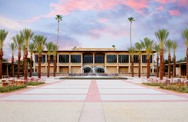 View of front of Hilb Building with a pink sky